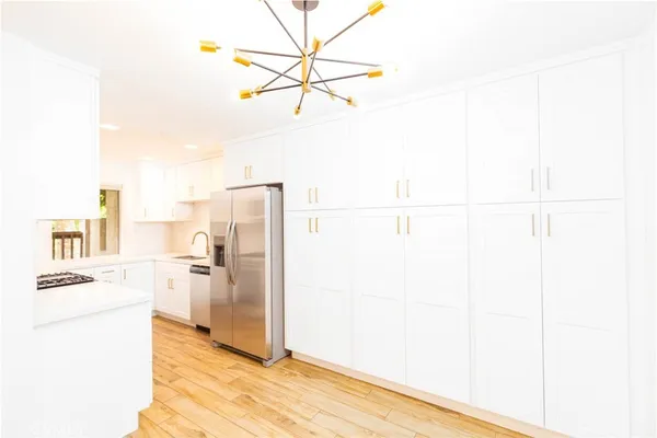 a kitchen with a refrigerator a stove and a microwave