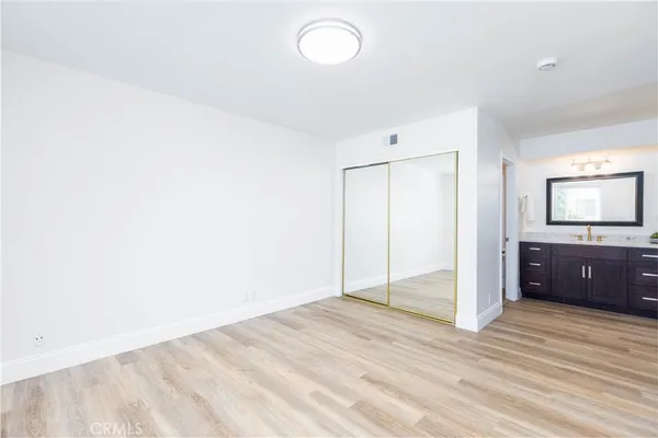 a view of a room with a sink and a mirror
