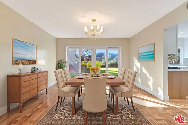 a large kitchen with stainless steel appliances kitchen island granite countertop a large counter top a stove a sink and a refrigerator