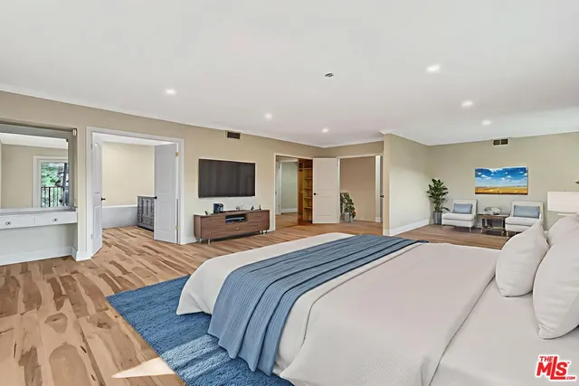 a bedroom with bed and a potted plant