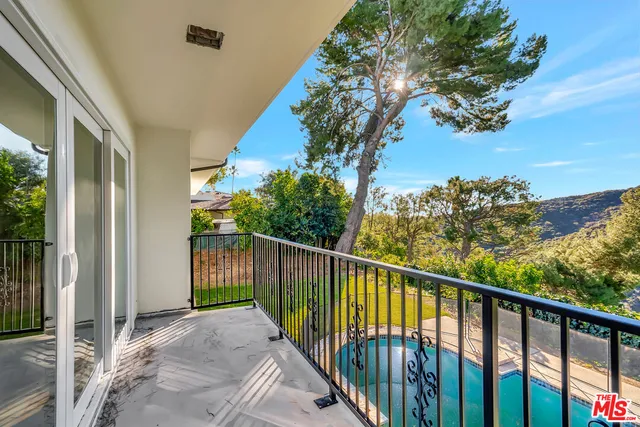 a bedroom with a large bed and a flat screen tv