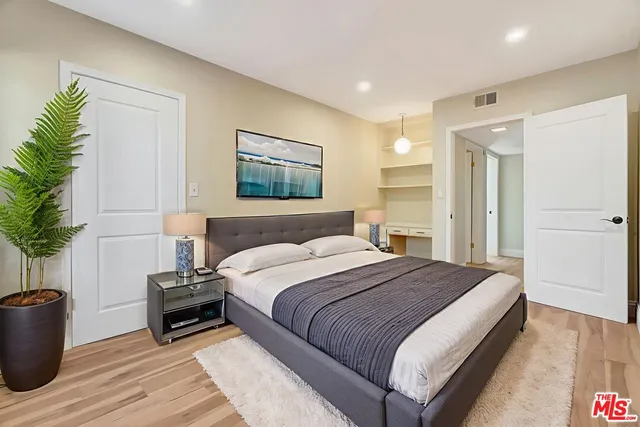 a front view of a house with a garden and yard