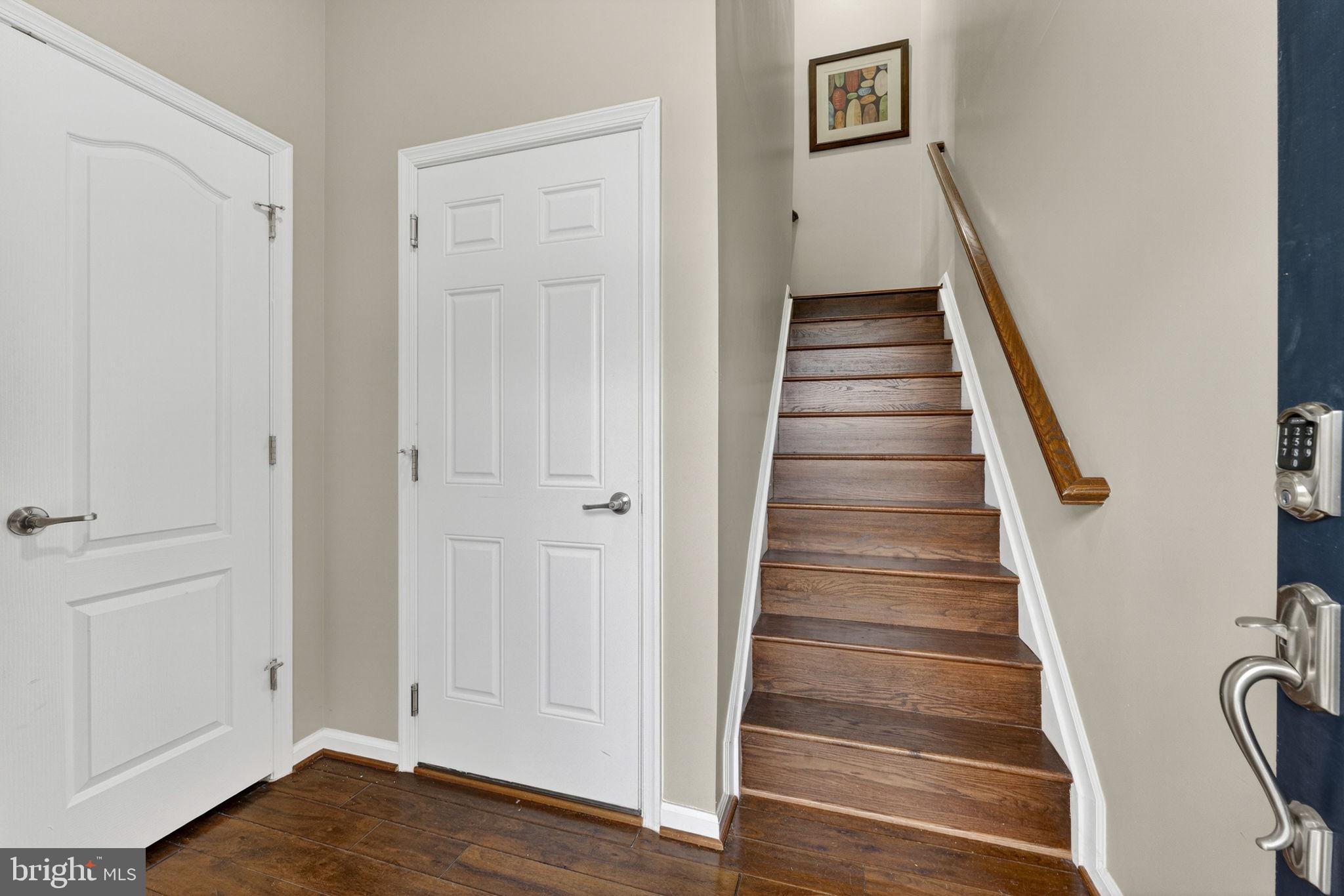 42558 Sunset Ridge Square Ashburn, VA 20148 - Photo 8 of 51 a view of a hallway with wooden floor and entryway