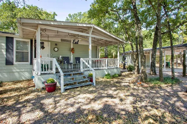 a view of backyard with deck and outdoor seating
