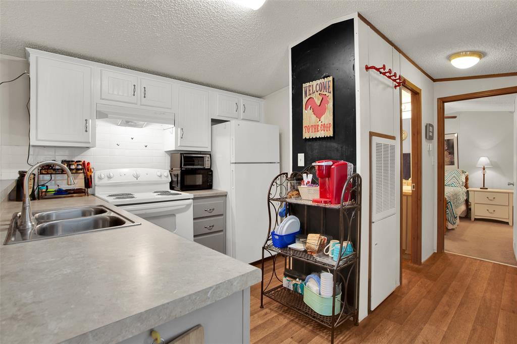 1793 Greer Road Sadler, TX 76264 - Photo 6 of 35 a kitchen with a refrigerator and a sink