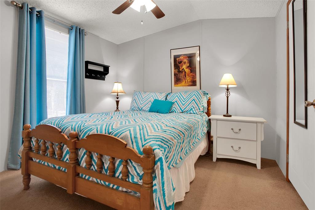 1793 Greer Road Sadler, TX 76264 - Photo 7 of 35 a bedroom with a bed and a lamp