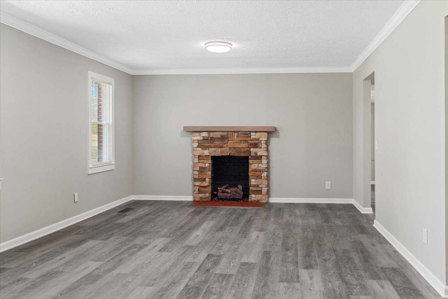2540 Grays Bend Road Centerville, TN 37033 - Photo 24 of 48 a view of an empty room with wooden floor fireplace and a window
