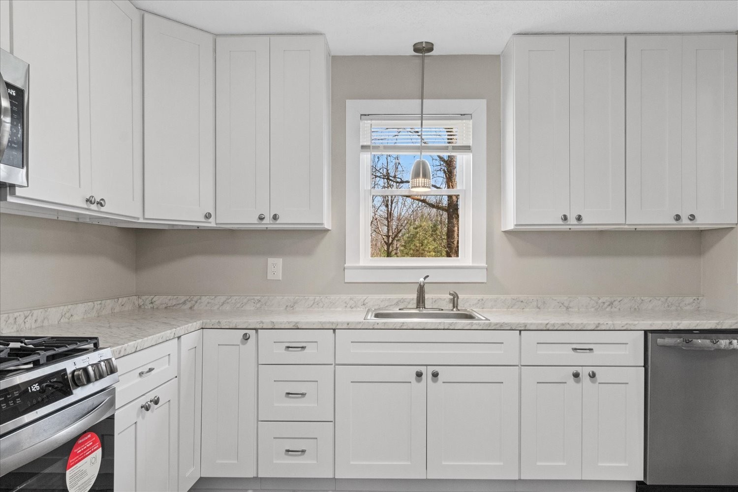 2540 Grays Bend Road Centerville, TN 37033 - Photo 30 of 48 a kitchen with granite countertop white cabinets and white appliances