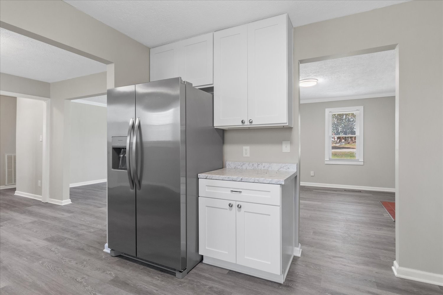 2540 Grays Bend Road Centerville, TN 37033 - Photo 32 of 48 a kitchen with stainless steel appliances granite countertop a refrigerator a sink and white cabinets with wooden floors