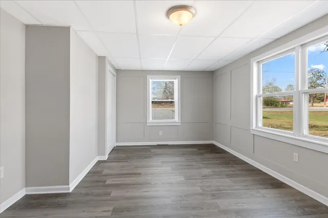 a big room with wooden floor and natural light
