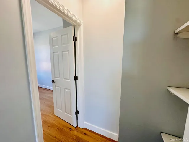 a view of front door with wooden floor