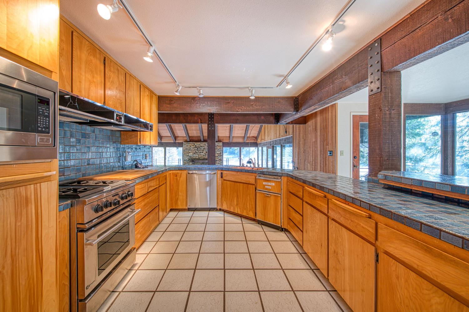 39326 Littlefield Road Shaver Lake, CA 93664 - Photo 12 of 49 a view of a kitchen with stainless steel appliances granite countertop a sink and cabinets