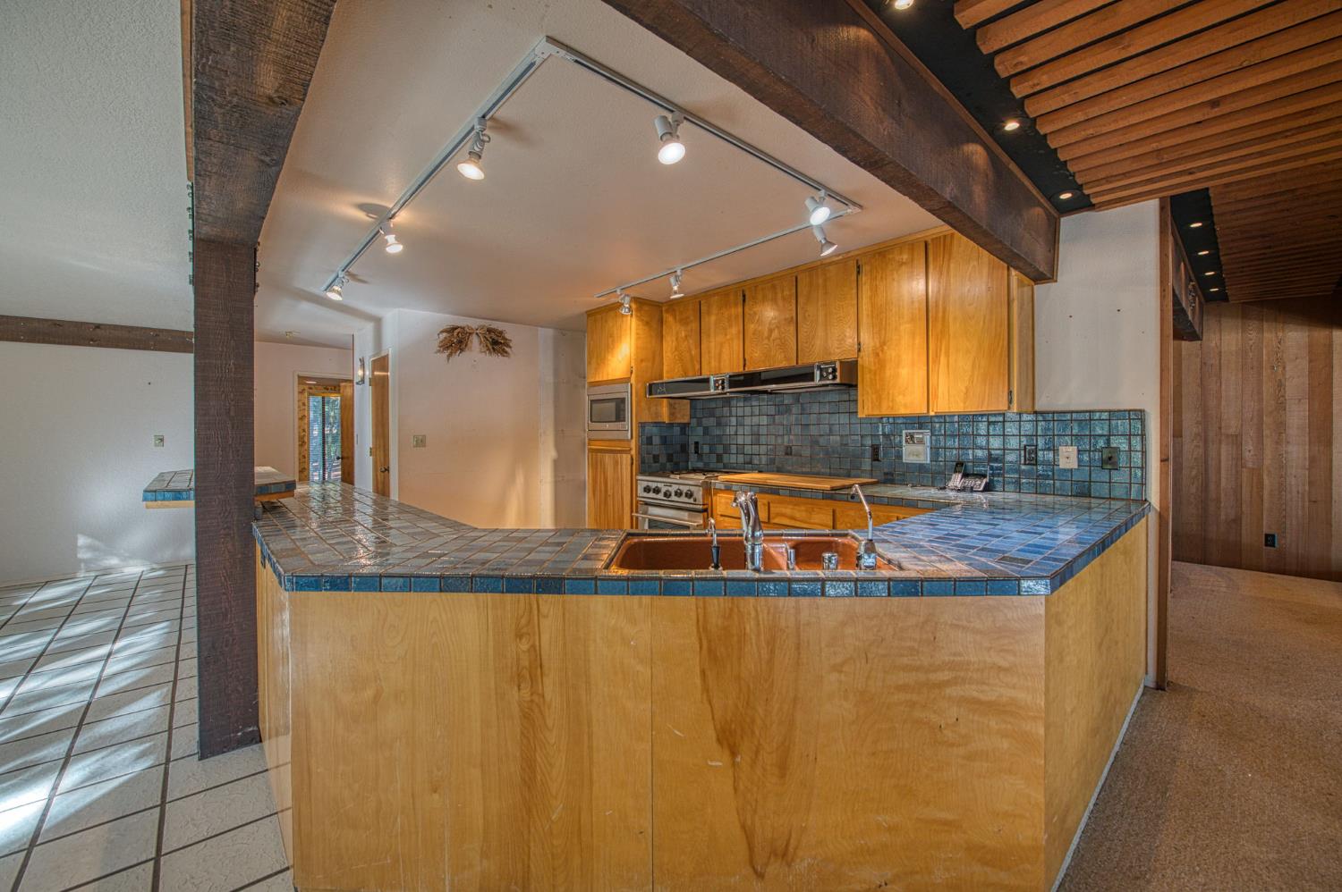 39326 Littlefield Road Shaver Lake, CA 93664 - Photo 13 of 49 a view of a kitchen with stainless steel appliances granite countertop a sink and a refrigerator