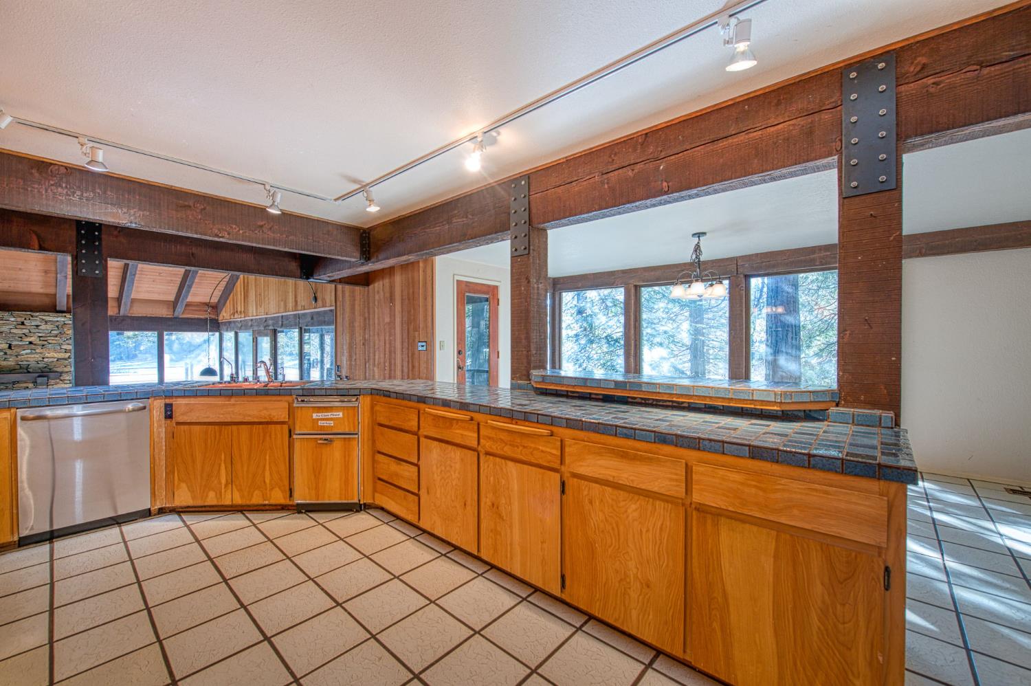 39326 Littlefield Road Shaver Lake, CA 93664 - Photo 14 of 49 a large kitchen with granite countertop a sink and cabinets