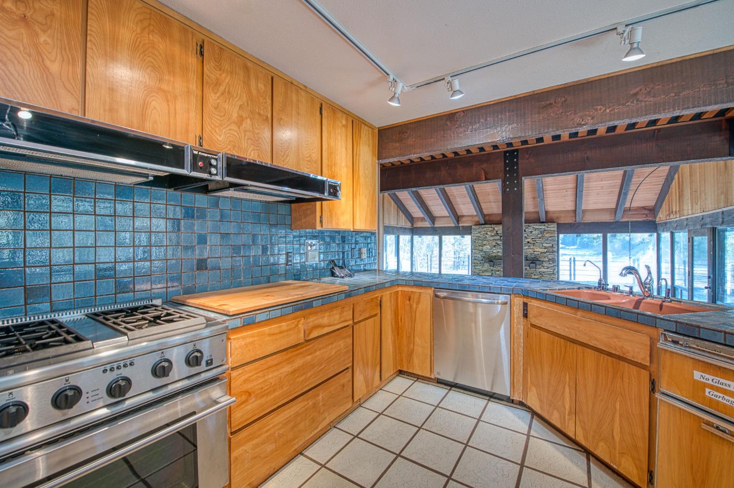 39326 Littlefield Road Shaver Lake, CA 93664 - Photo 15 of 49 a kitchen with a stove and a sink