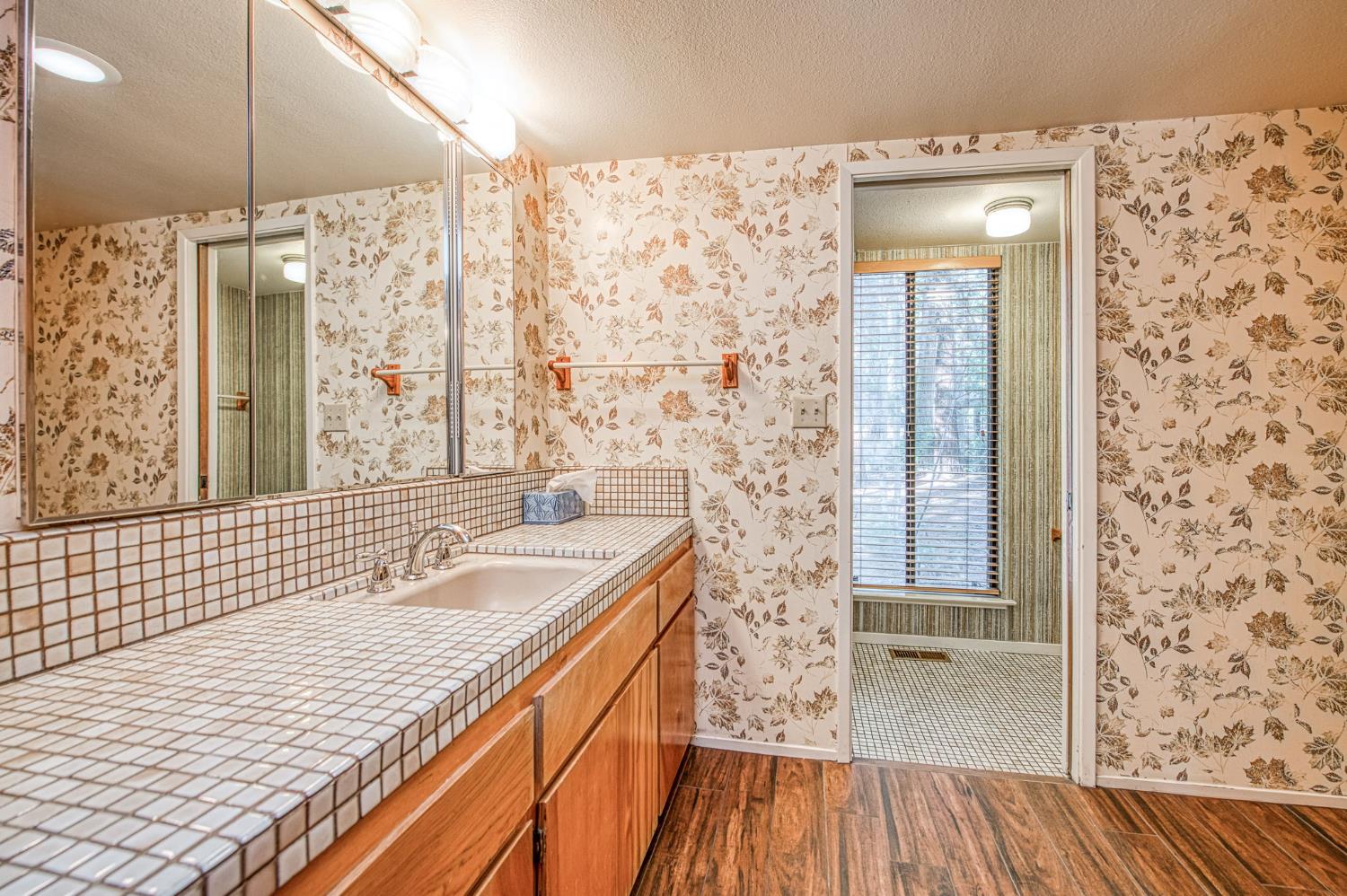 39326 Littlefield Road Shaver Lake, CA 93664 - Photo 19 of 49 a bathroom with a granite countertop sink toilet and shower