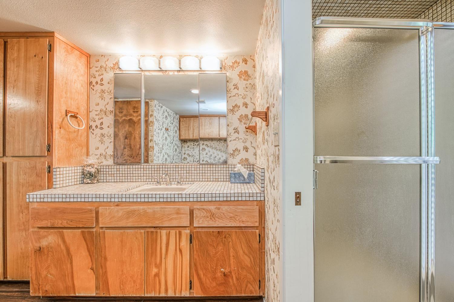 39326 Littlefield Road Shaver Lake, CA 93664 - Photo 21 of 49 a bathroom with a shower and a sink