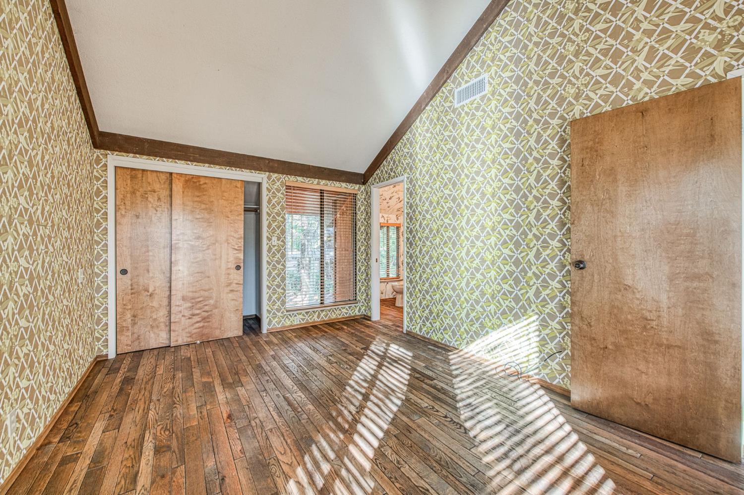 39326 Littlefield Road Shaver Lake, CA 93664 - Photo 31 of 49 a view of a room with wooden floor and a bathroom