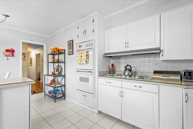 a kitchen with cabinets and window