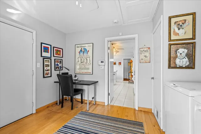 a bedroom with a bed and dresser with mirror