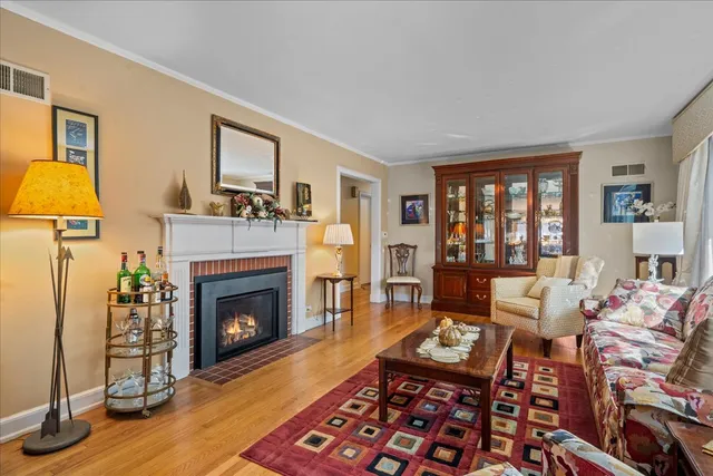 a living room with furniture fireplace and a large window