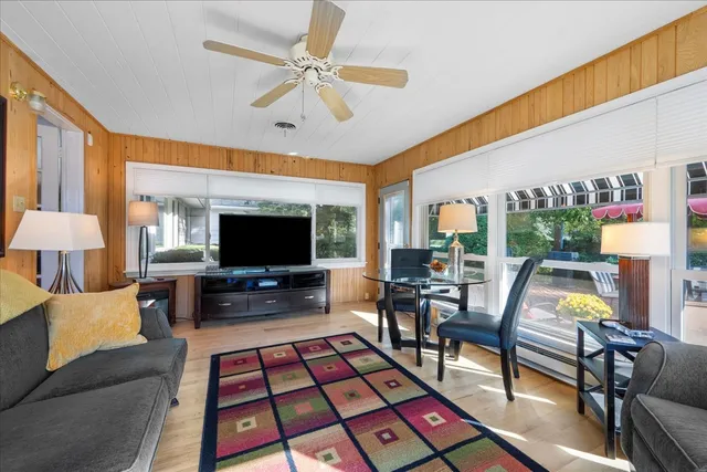 a kitchen with stainless steel appliances kitchen island granite countertop a table chairs and a refrigerator