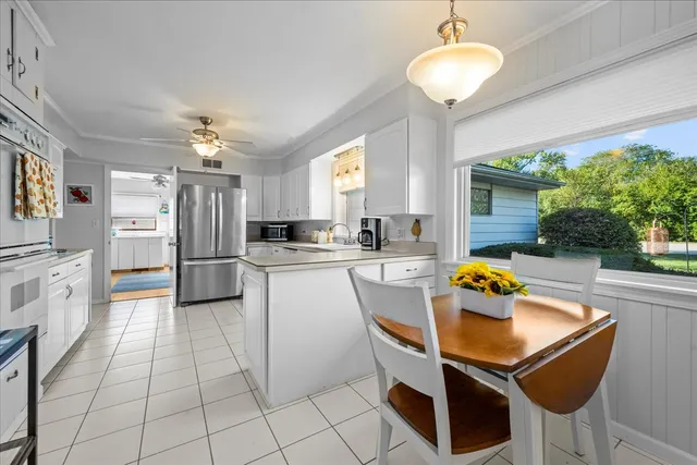 a kitchen with granite countertop a refrigerator and a sink