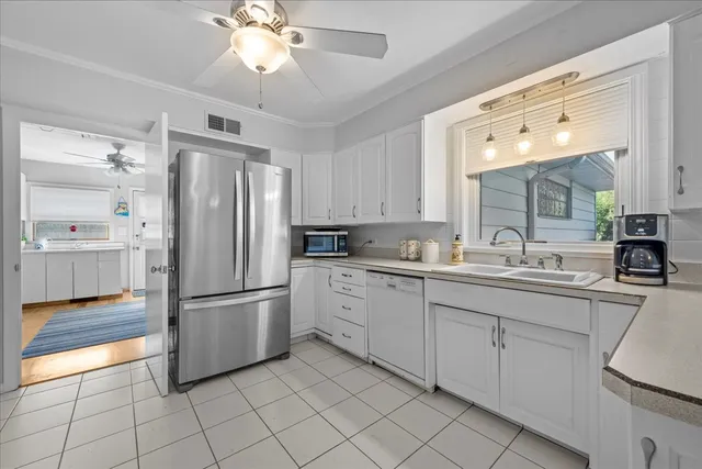 a kitchen with white cabinets and white appliances