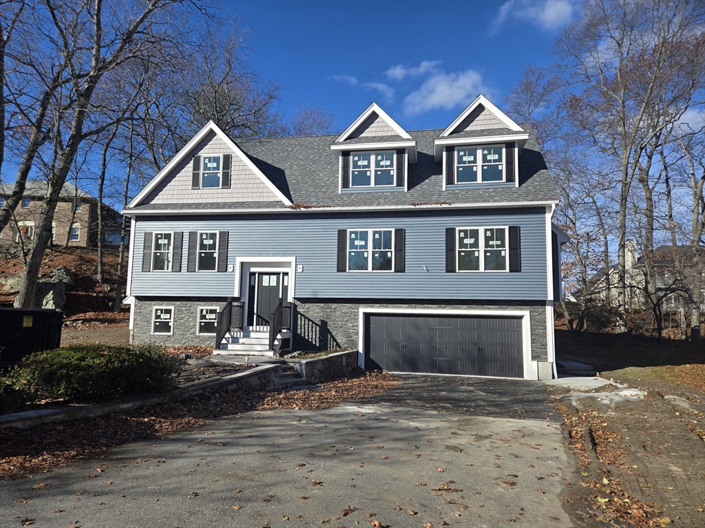 39 Tamarock Terrace Stoneham, MA 02180 - Photo 1 of 13 a front view of a house with yard and trees
