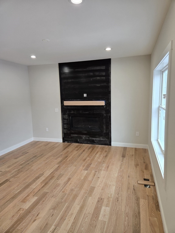 39 Tamarock Terrace Stoneham, MA 02180 - Photo 13 of 13 a view of an empty room with wooden floor and a window
