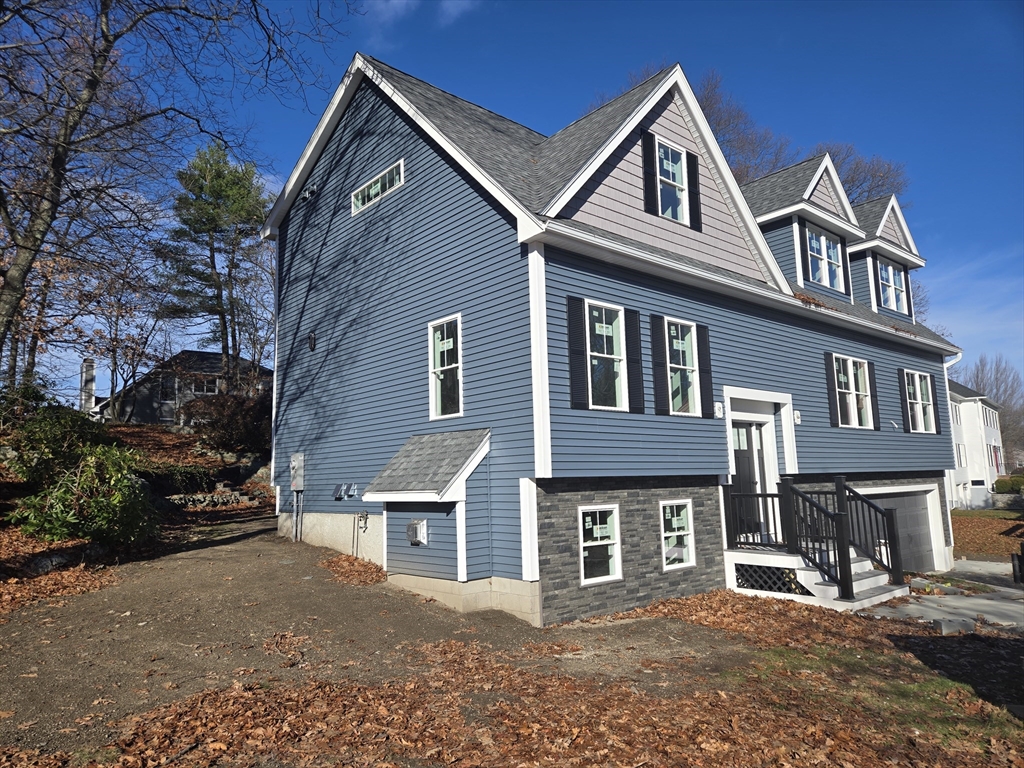 39 Tamarock Terrace Stoneham, MA 02180 - Photo 2 of 13 a front view of a house with a yard