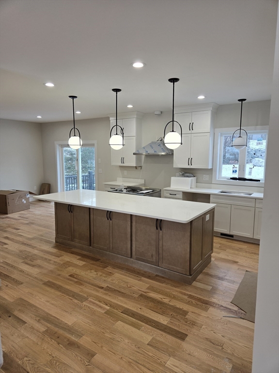 39 Tamarock Terrace Stoneham, MA 02180 - Photo 5 of 13 a large kitchen with granite countertop a large counter top a sink stainless steel appliances and cabinets