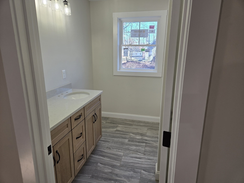 39 Tamarock Terrace Stoneham, MA 02180 - Photo 7 of 13 a bathroom with a sink a vanity and a window