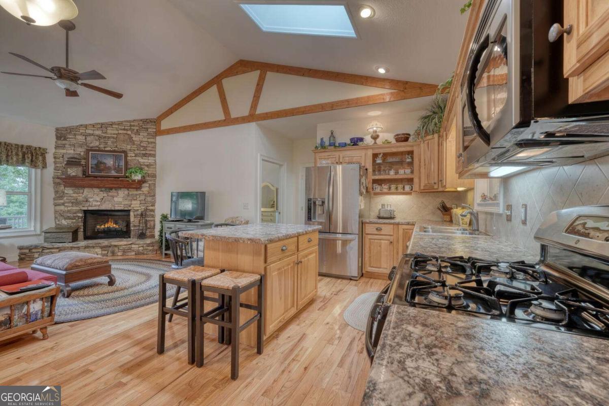 523 Sunnyside Shores Road Hiawassee, GA 30546 - Photo 14 of 55 a living room with furniture a fireplace and a flat screen tv
