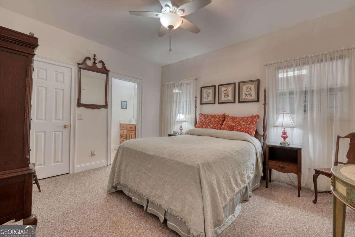 523 Sunnyside Shores Road Hiawassee, GA 30546 - Photo 15 of 55 a bedroom with a large bed and a chandelier