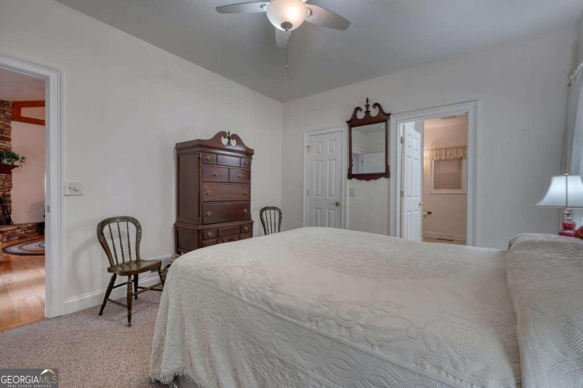 523 Sunnyside Shores Road Hiawassee, GA 30546 - Photo 16 of 55 a bedroom with a bed and a chair