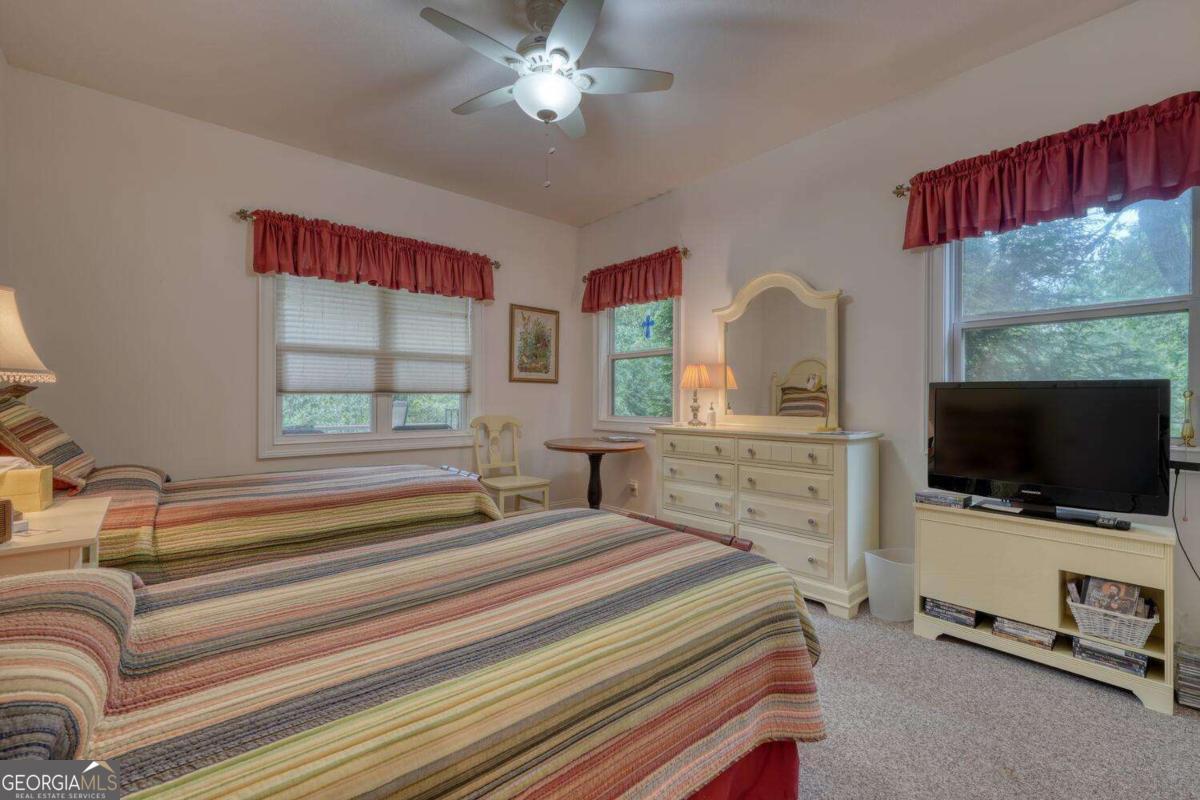 523 Sunnyside Shores Road Hiawassee, GA 30546 - Photo 20 of 55 a bedroom with a bed and a flat screen tv