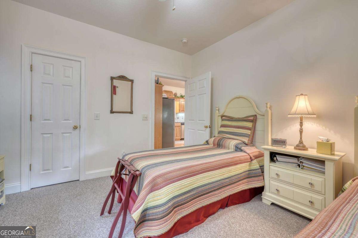 523 Sunnyside Shores Road Hiawassee, GA 30546 - Photo 22 of 55 a bedroom with a bed and a dresser
