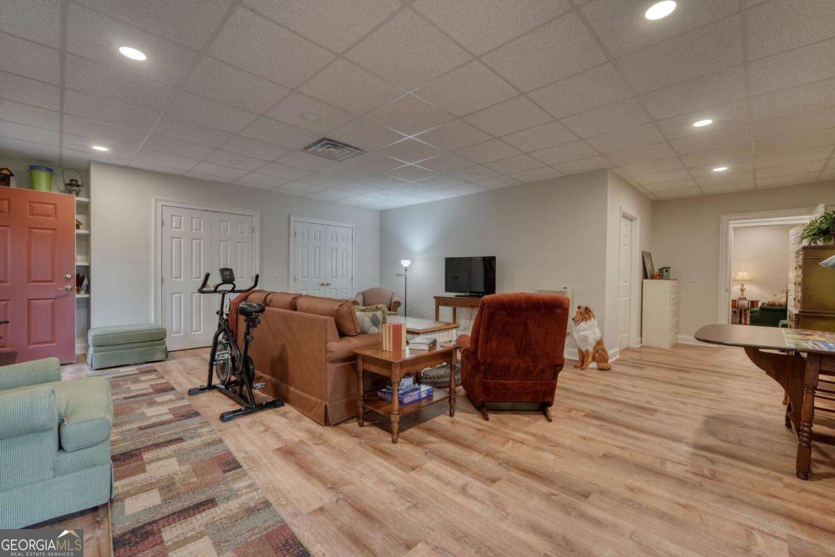 523 Sunnyside Shores Road Hiawassee, GA 30546 - Photo 29 of 55 a living room with furniture a flat screen tv and a table