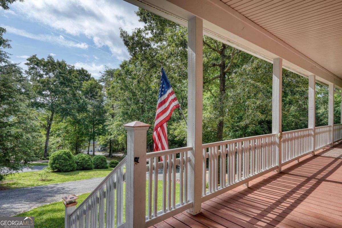 523 Sunnyside Shores Road Hiawassee, GA 30546 - Photo 39 of 55 a view of a wooden deck next to a yard
