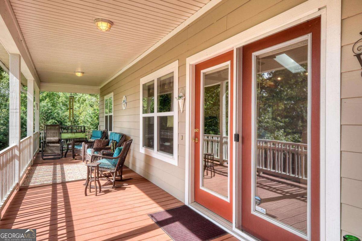 523 Sunnyside Shores Road Hiawassee, GA 30546 - Photo 7 of 55 a balcony with chairs and wooden floor