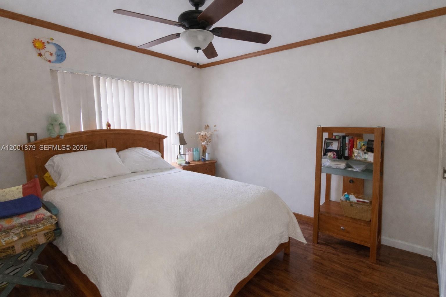 5524 Constant Spring Terrace, Unit 213 Lauderhill, FL 33319 - Photo 15 of 16 a bedroom with a bed and a window