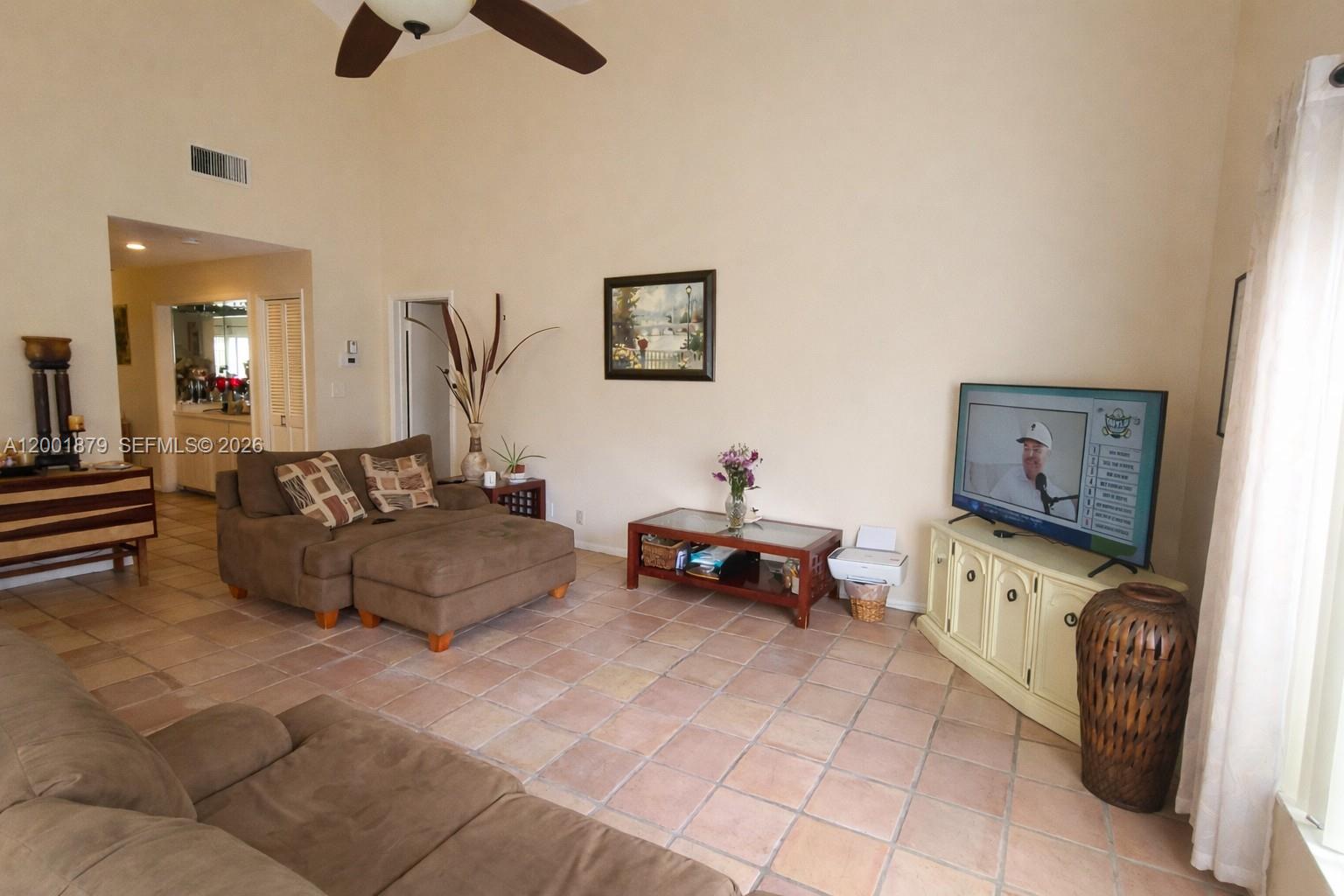 5524 Constant Spring Terrace, Unit 213 Lauderhill, FL 33319 - Photo 4 of 16 a living room with furniture and a flat screen tv