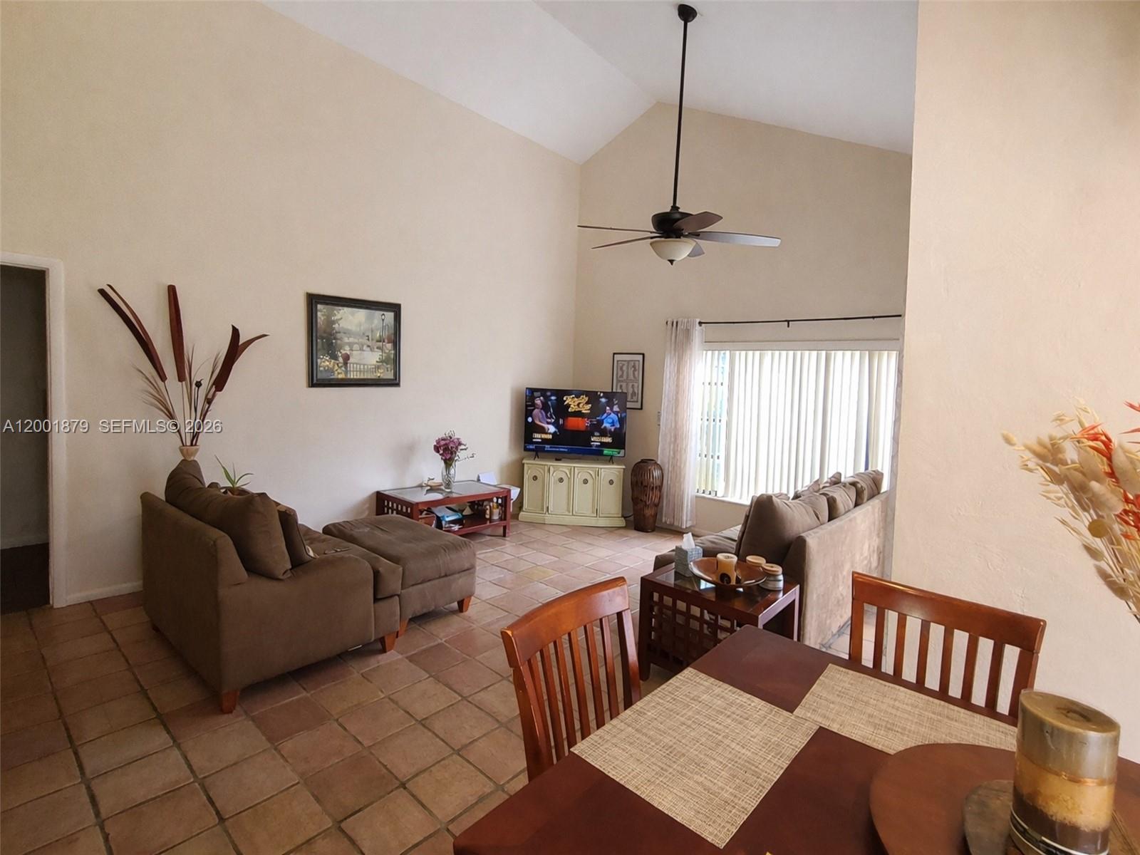 5524 Constant Spring Terrace, Unit 213 Lauderhill, FL 33319 - Photo 5 of 16 a living room with furniture a flat screen tv and a window