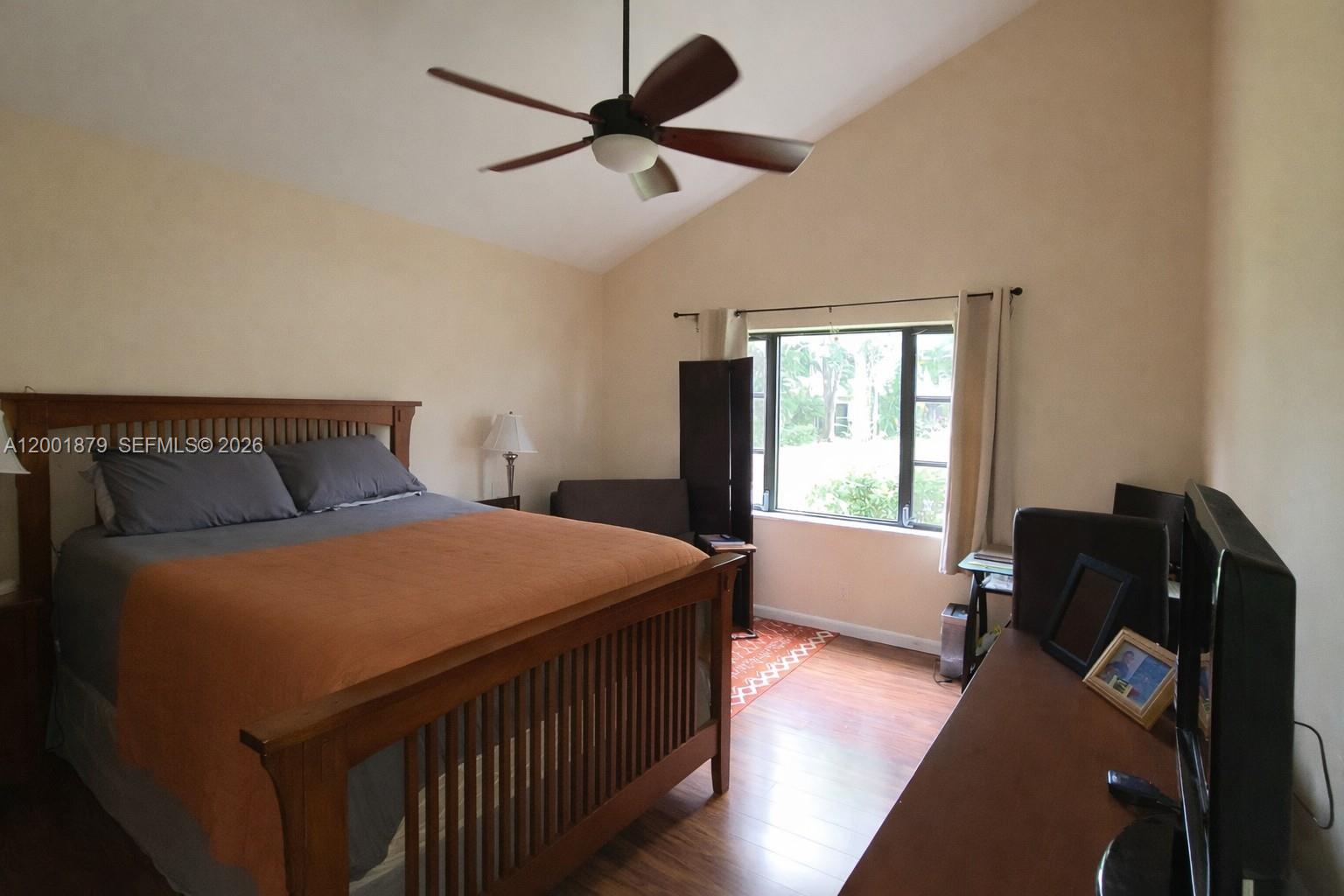 5524 Constant Spring Terrace, Unit 213 Lauderhill, FL 33319 - Photo 9 of 16 a bedroom with a bed and wooden floor