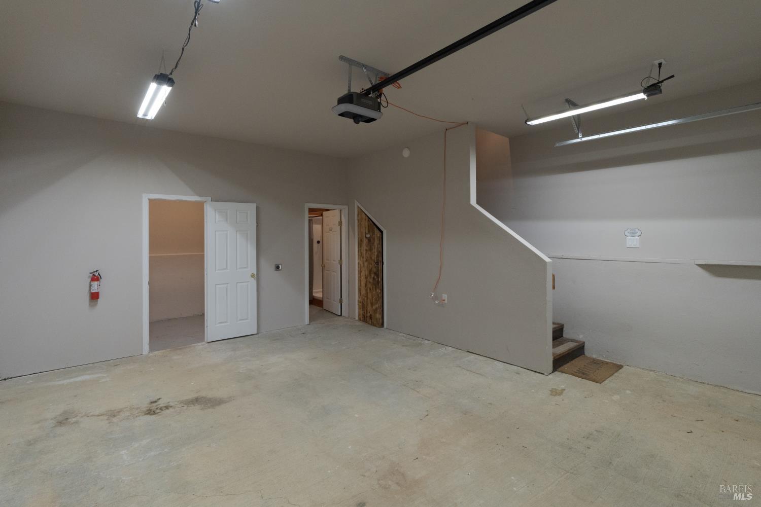 44000 Iversen Road Gualala, CA 95445 - Photo 35 of 57 20 x 20 garage with laundry and full bath and stairwell to upstairs ADU, this is adjacent to large shop bay with designated garage door.