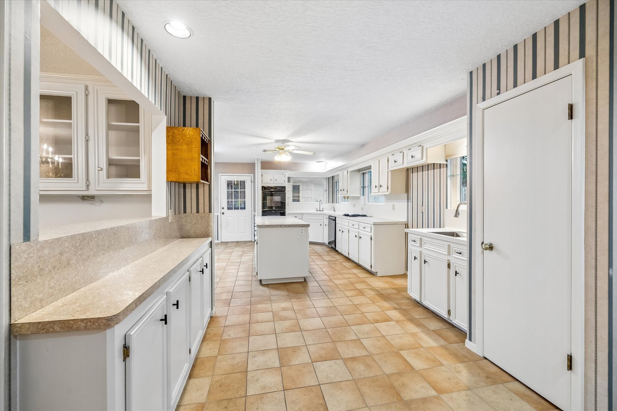 5515 Sylmar Road Houston, TX 77081 - Photo 7 of 28 This kitchen is H U G E, with serving counters , center island ,built-in desk area, and enough space to have a breakfast- sized dining set.