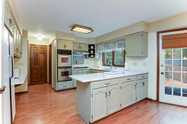 a kitchen with stainless steel appliances granite countertop a refrigerator and a sink