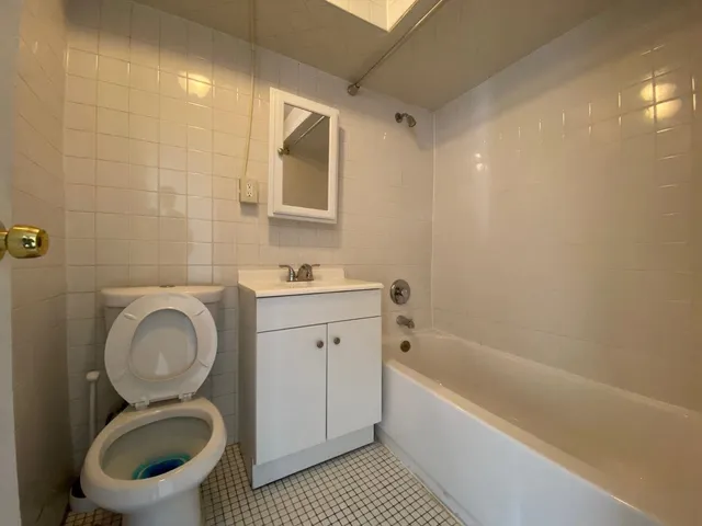 a bathroom with a toilet a sink and bathtub