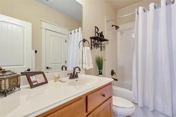 a bathroom with a sink double vanity mirror and toilet